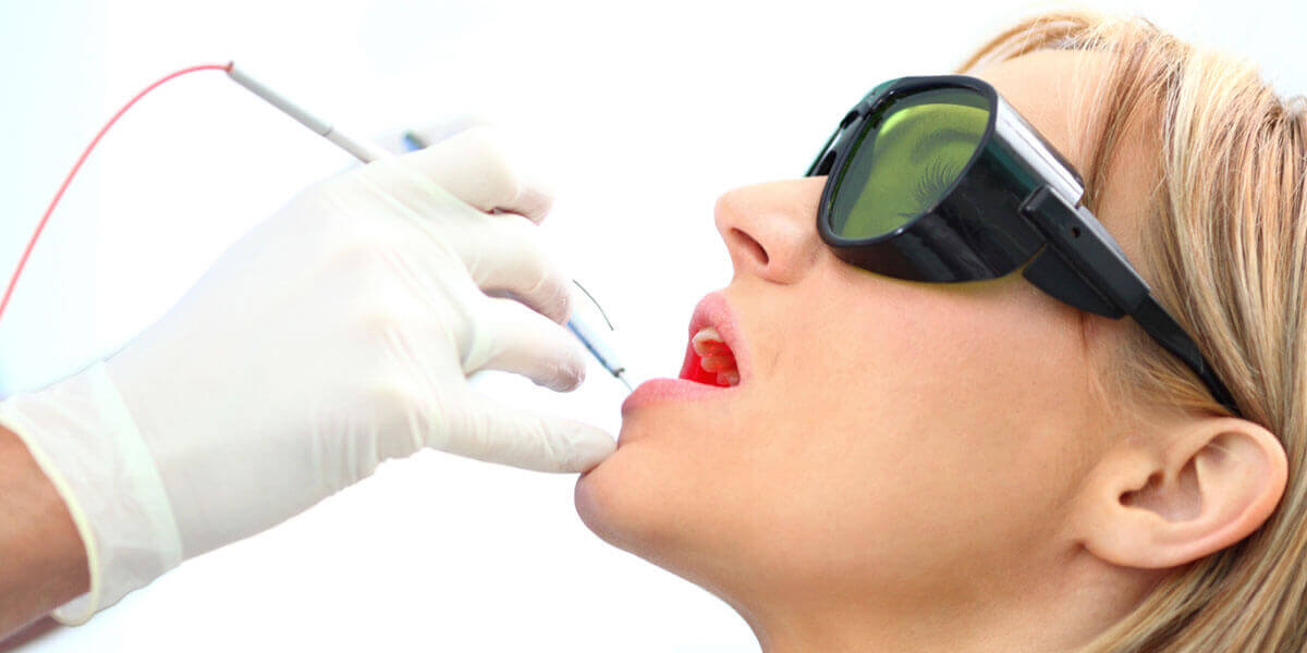 woman receiving laser dental treatment