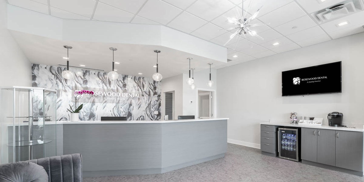 front desk area of Rosewood Dental, decorated in white and grey