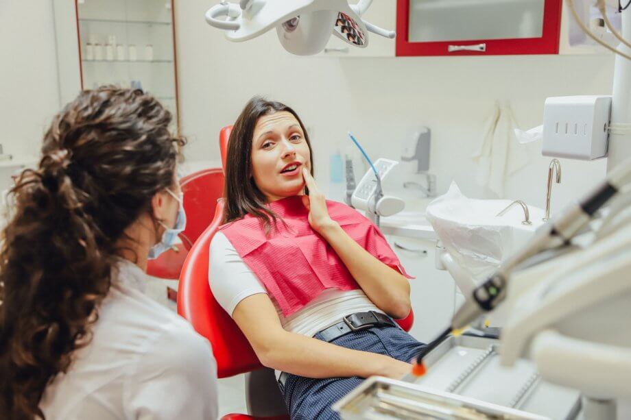 girl in pain at dentist office