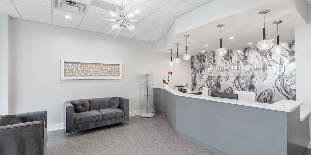 front desk area of Rosewood Dental, decorated in white and grey